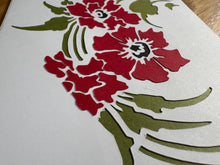 Load image into Gallery viewer, alternate angle of white card with red flowers and green leaves made from cut-paper