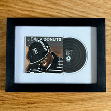Load image into Gallery viewer, Framed J Dilla &#39;Donuts&#39; vinyl record and cover on a wooden surface
